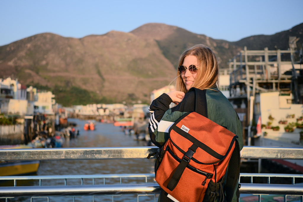 Slacker Bag in Rust being featured in front of one of the many islands surrounding Hong Kong