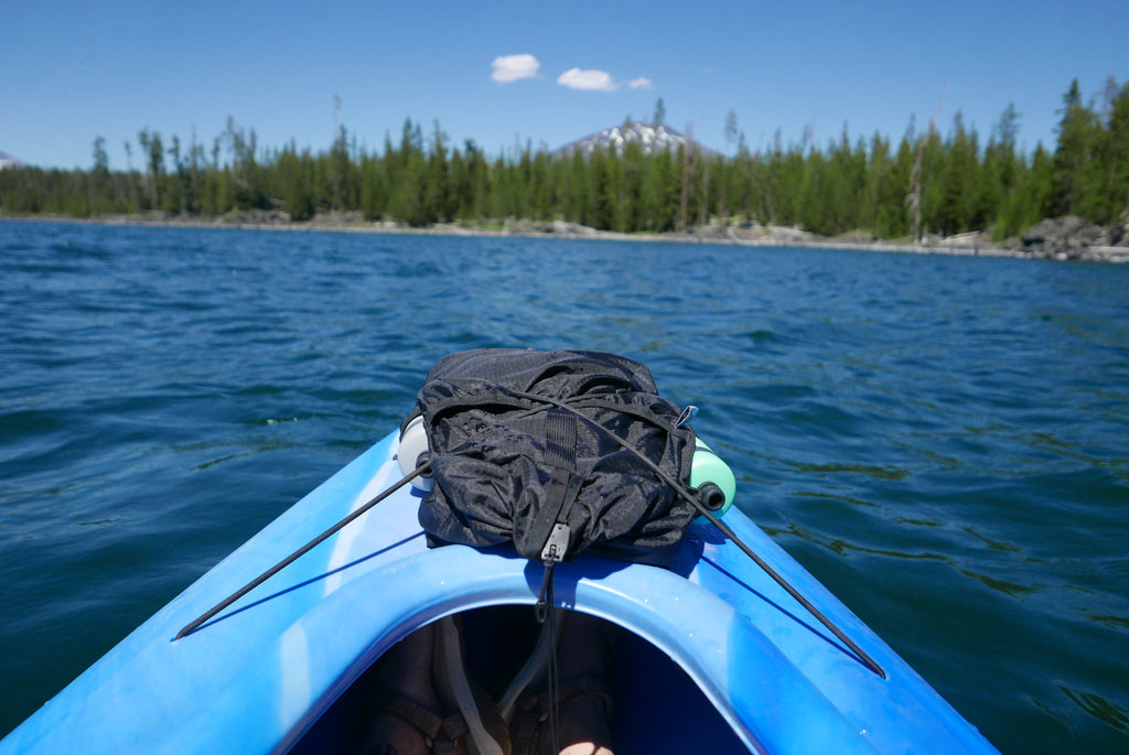 Comrad Packable Backpack on the nose of a Canoe