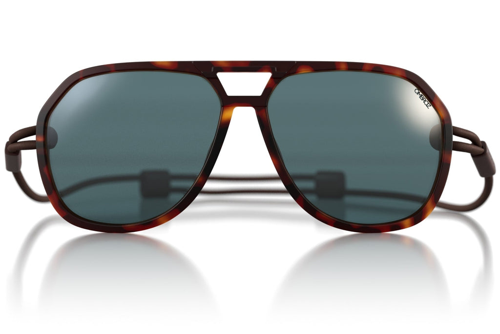 Sunglasses with tortoiseshell frame and dark lenses on a white background