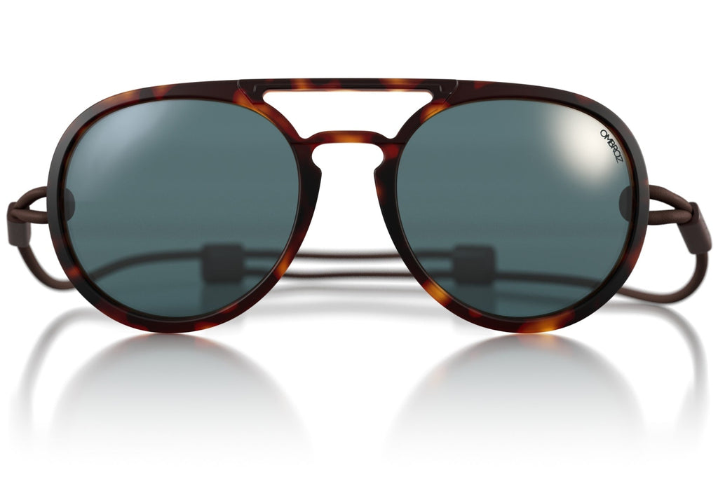 Sunglasses with tortoiseshell frame and dark lenses on a white background